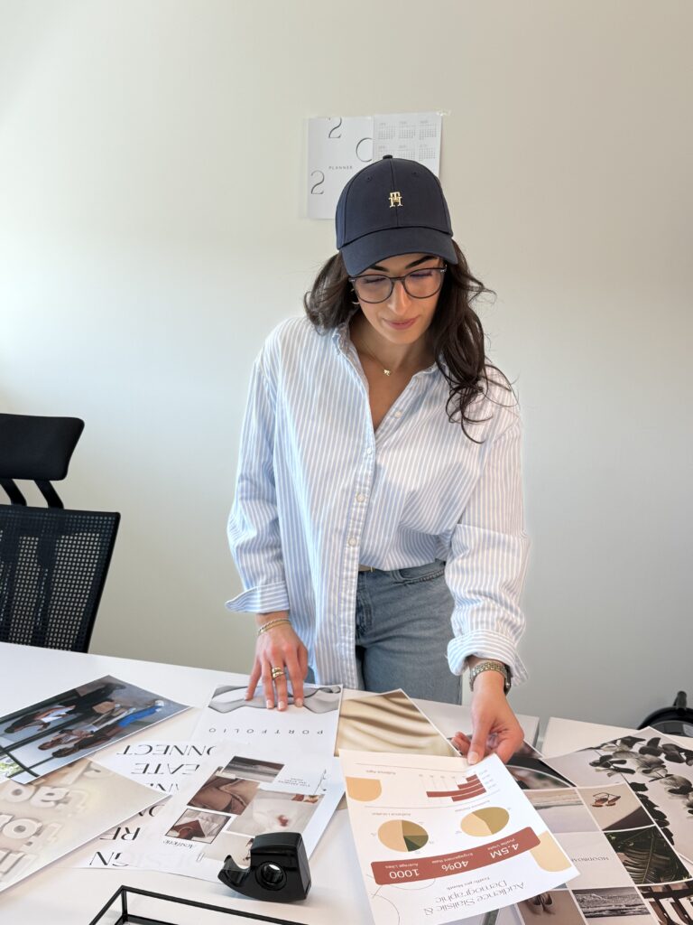 Esme Uensal in a blue blazer sorting prints