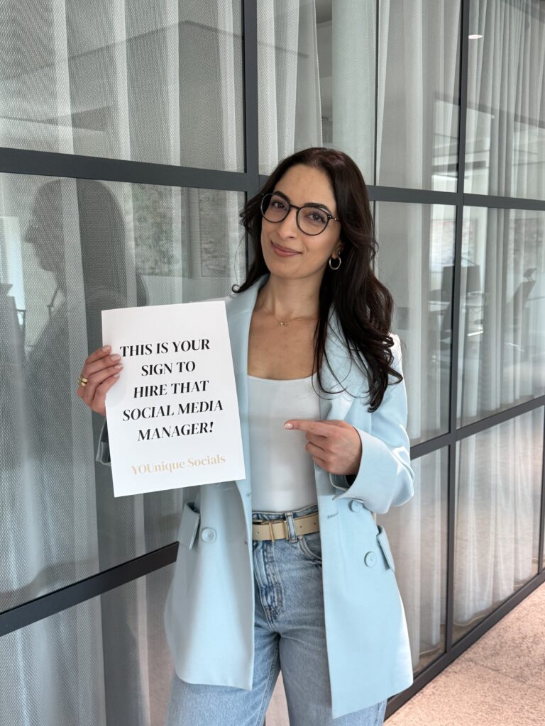 Esme holding a letter stating that this is your sign to hire a social media manager